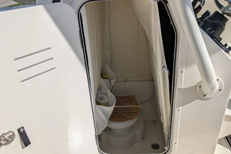 Slide: The Image of 2025 Key West 263 FS boat interior with compact marine toilet. - 13