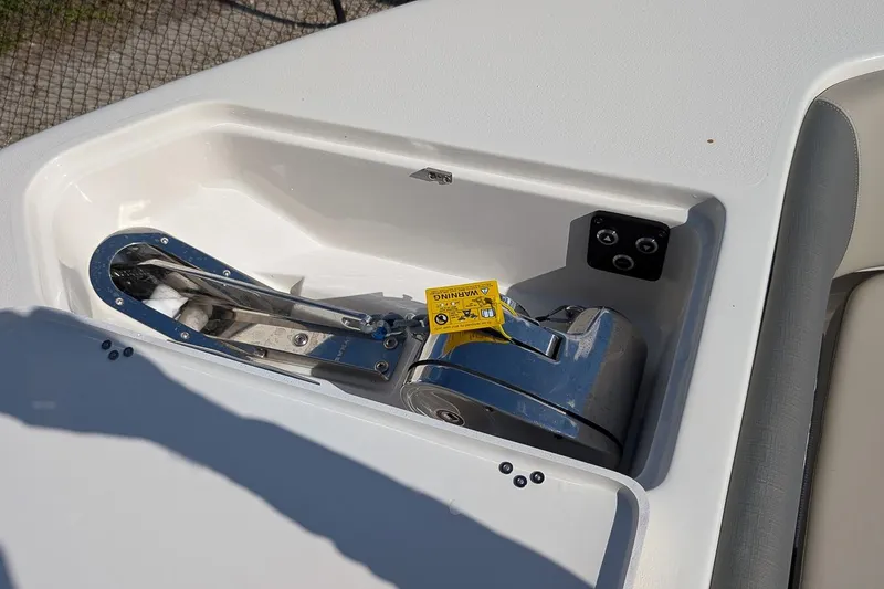 Slide: The Image of 2025 Key West 263 FS boat anchor compartment with warning label and control buttons. - 17