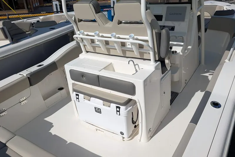 Slide: The Image of 2025 Key West 263 FS boat interior with seating, rod holders, and storage. - 7