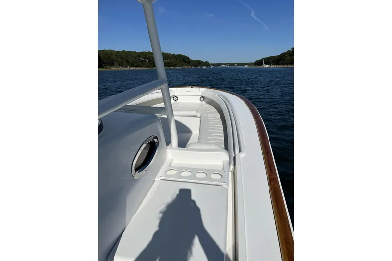 Slide: The Image of 2011 Regulator 34SS boat on calm water, showcasing sleek design and seating area. - 3
