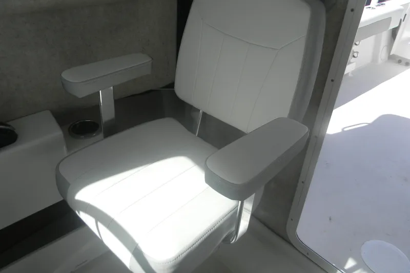 Slide: The Image of 2024 Parker 2320 SL Sport Cabin interior with white cushioned seat and armrests. - 10