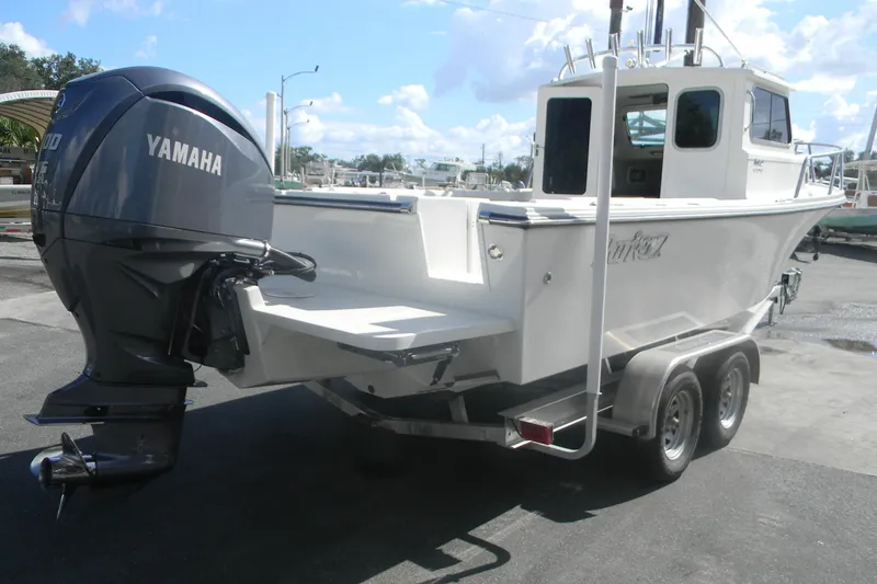 Slide: The Image of 2024 Parker 2320 SL Sport Cabin boat with Yamaha engine on a trailer. - 3