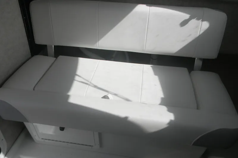 Slide: The Image of 2024 Parker 2320 SL Sport Cabin interior seating, white cushioned bench in sunlight. - 4