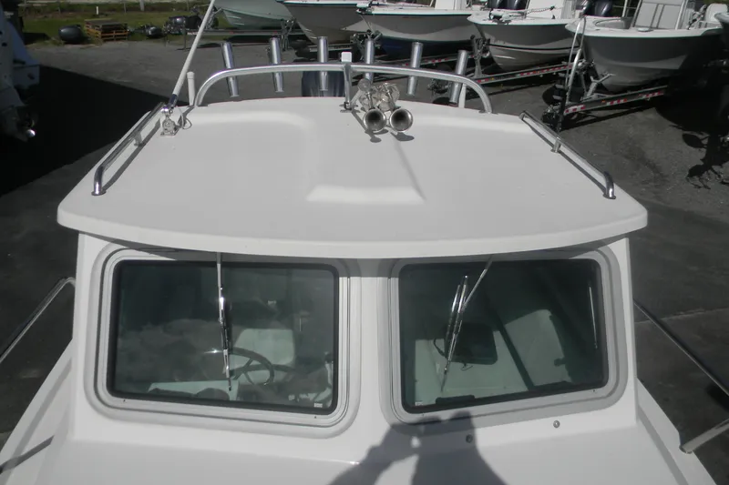 Slide: The Image of 2024 Parker 2320 SL Sport Cabin boat, top view of cabin and windows. - 5