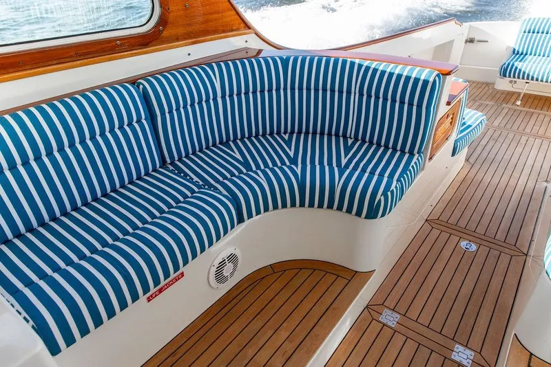 Slide: The Image of Luxurious 2007 Hinckley Talaria 40 yacht interior with striped seating and teak flooring. - 13