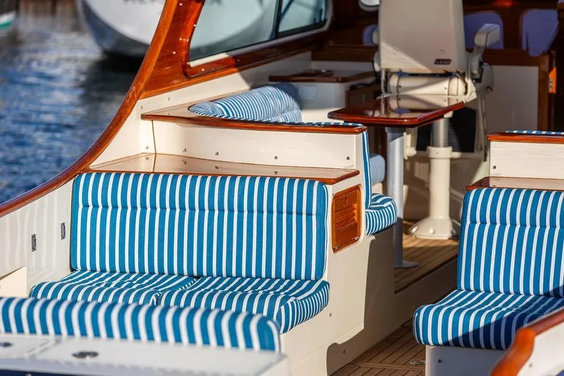 Slide: The Image of Hinckley Talaria 40 (2007) interior with blue striped seating and wooden accents. - 14