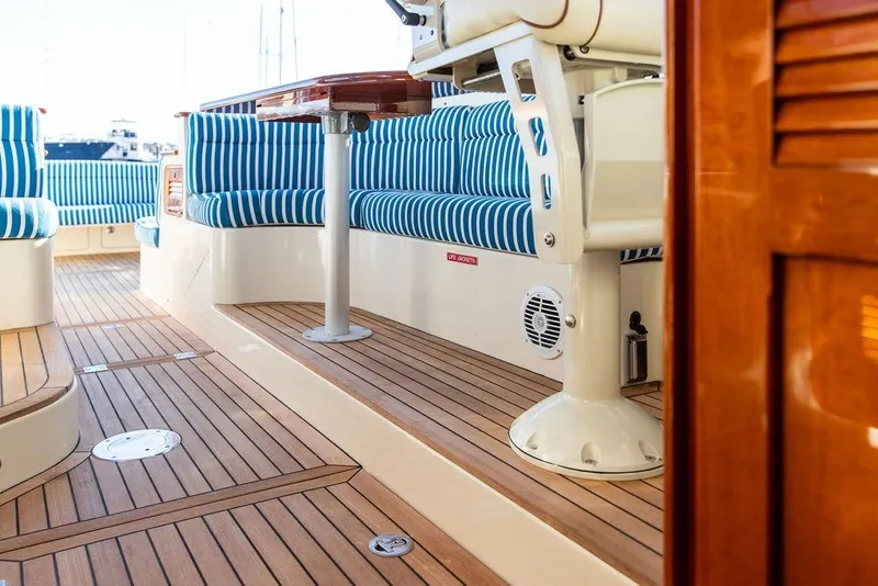 Slide: The Image of 2007 Hinckley Talaria 40 interior with striped seating and polished wood flooring. - 15