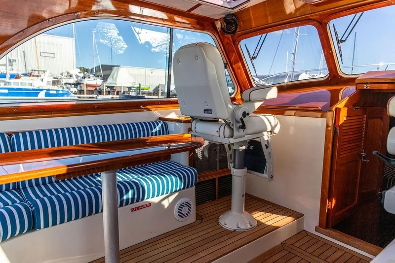 Slide: The Image of Interior of 2007 Hinckley Talaria 40 yacht with striped seating and wooden finishes. - 16