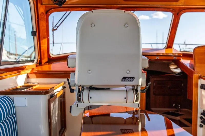 Slide: The Image of Interior of 2007 Hinckley Talaria 40 yacht with polished wood and captain's chair. - 18