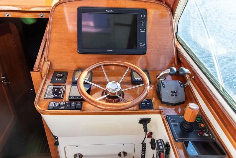 Slide: The Image of Hinckley Talaria 40 yacht helm with wooden steering wheel and navigation controls, 2007 model. - 19