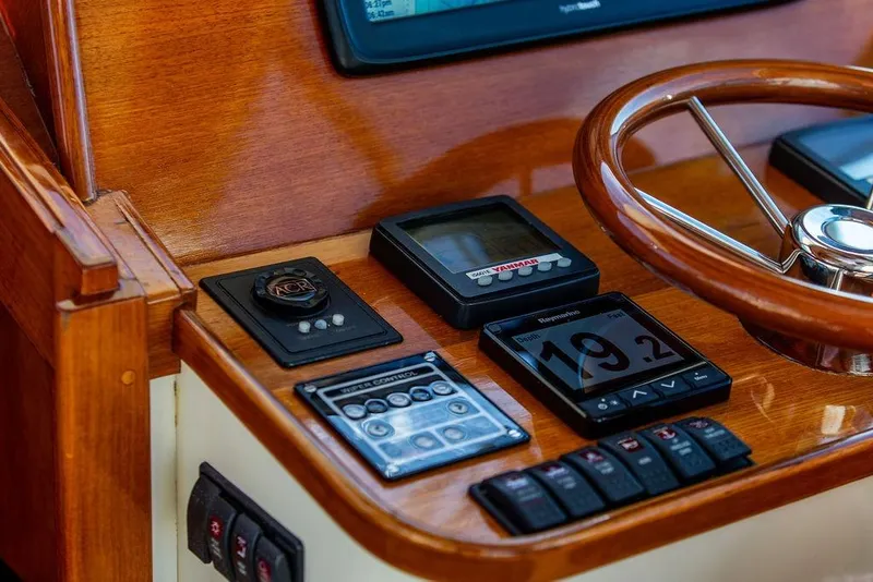 Slide: The Image of 2007 Hinckley Talaria 40 helm with wooden steering wheel and navigation instruments. - 20