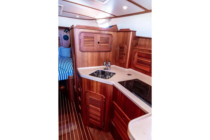 Slide: The Image of Luxurious wooden interior of 2007 Hinckley Talaria 40 yacht kitchen area. - 24