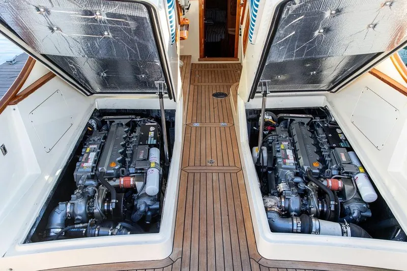 Slide: The Image of Engine compartment of 2007 Hinckley Talaria 40 yacht with twin engines and wooden deck. - 32