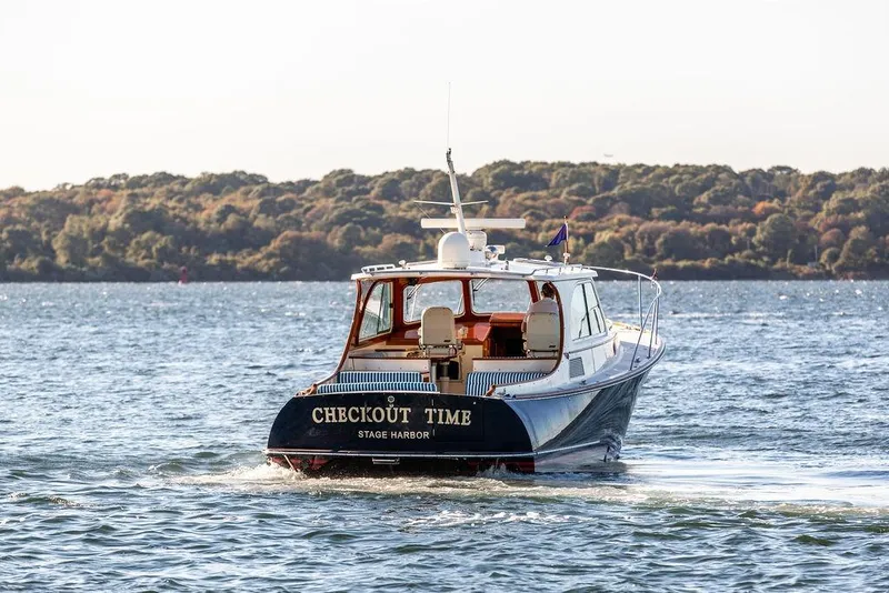 Slide: The Image of 2007 Hinckley Talaria 40 yacht cruising on water, "Checkout Time" at Stage Harbor. - 5