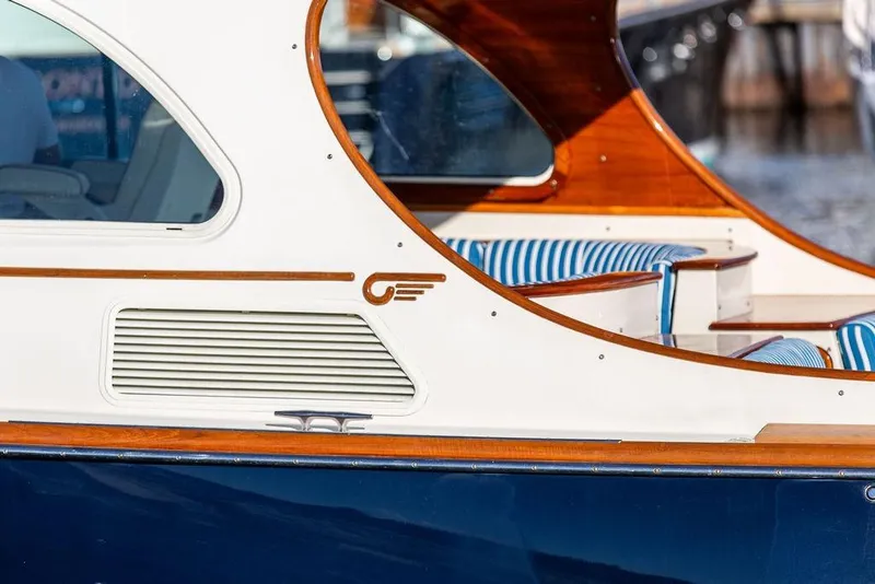 Slide: The Image of 2007 Hinckley Talaria 40 yacht with elegant wood trim and striped seating. - 8