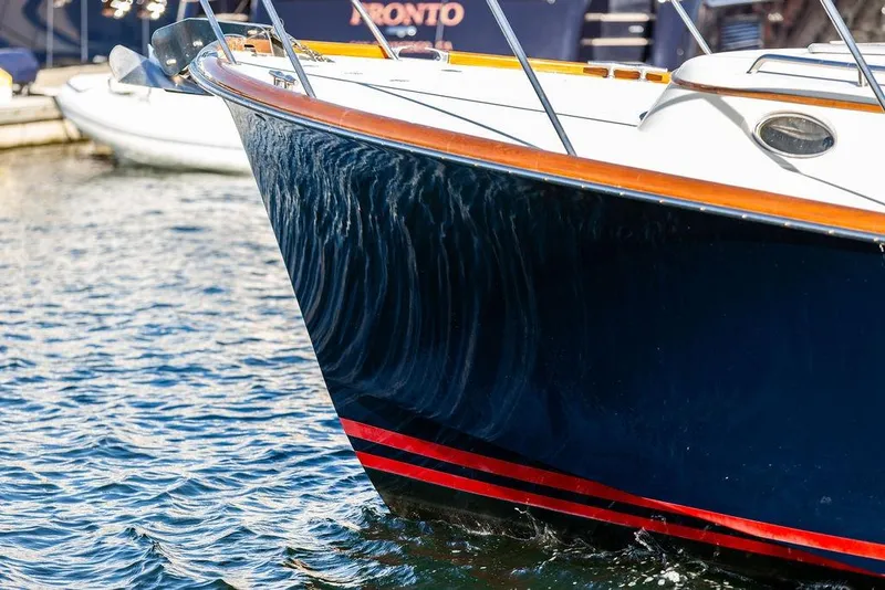 Slide: The Image of 2007 Hinckley Talaria 40 yacht with sleek hull design on water. - 9