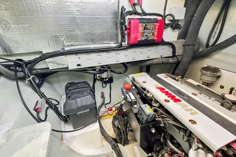 Slide: The Image of Engine room of a 2021 Leopard 45 yacht featuring a Yanmar engine and electrical components. - 102