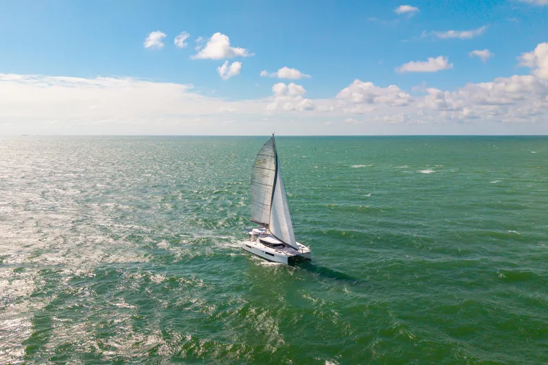 Slide: The Image of Sailing catamaran Leopard 45, 2021 model, cruising on open sea under clear blue sky. - 107