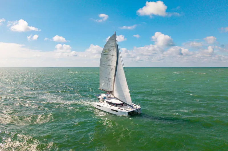 Slide: The Image of 2021 Leopard 45 sailing catamaran on open sea under clear blue sky. - 108