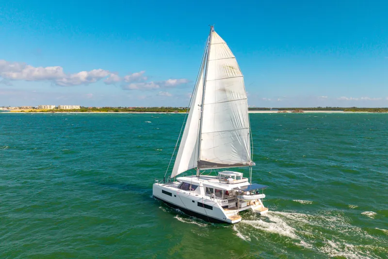 Slide: The Image of Sailing catamaran Leopard 45, 2021 model, cruising on open sea under clear blue sky. - 110