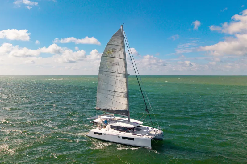 Slide: The Image of Sailing catamaran Leopard 45, 2021 model, cruising on open sea under clear blue sky. - 115