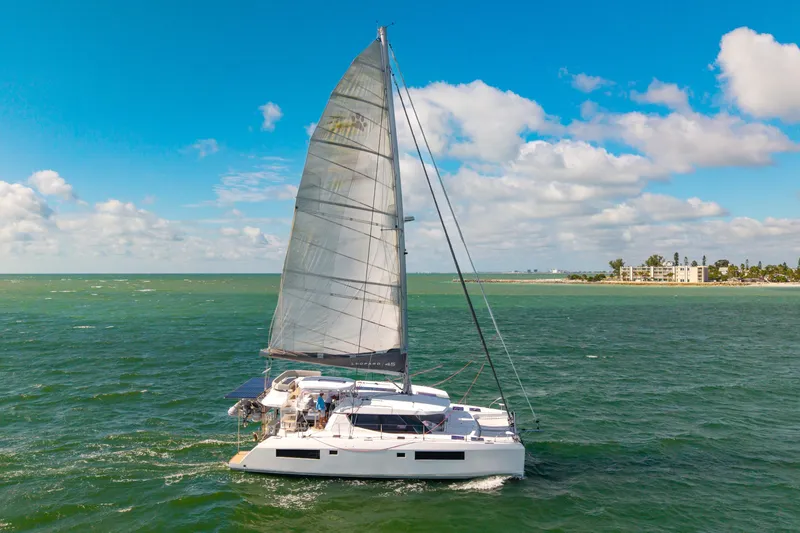 Slide: The Image of Sailing catamaran Leopard 45, 2021 model, cruising on open sea under clear blue skies. - 116