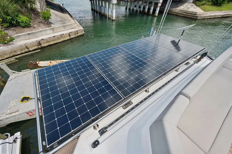 Slide: The Image of Solar panels on a 2021 Leopard 45 catamaran docked near a bridge. - 14