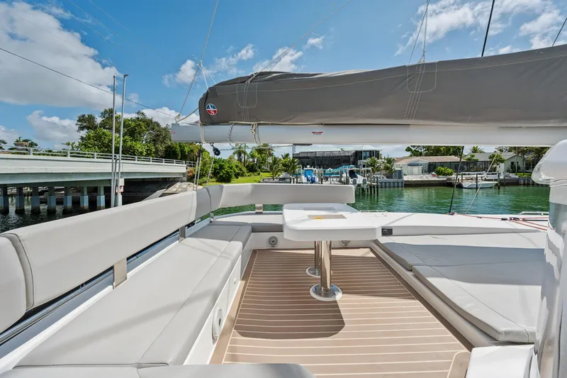 Slide: The Image of Luxurious 2021 Leopard 45 catamaran with spacious deck seating and scenic waterfront view. - 17