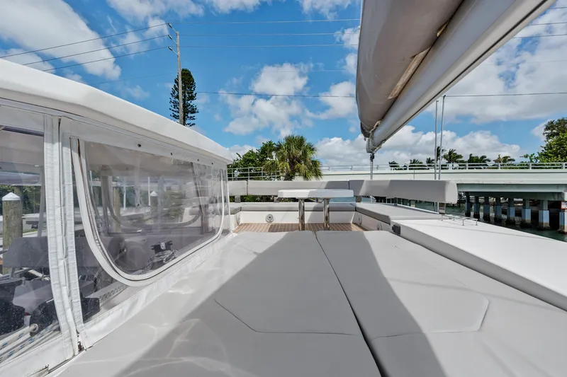 Slide: The Image of 2021 Leopard 45 yacht deck with seating, clear skies, and bridge in background. - 20