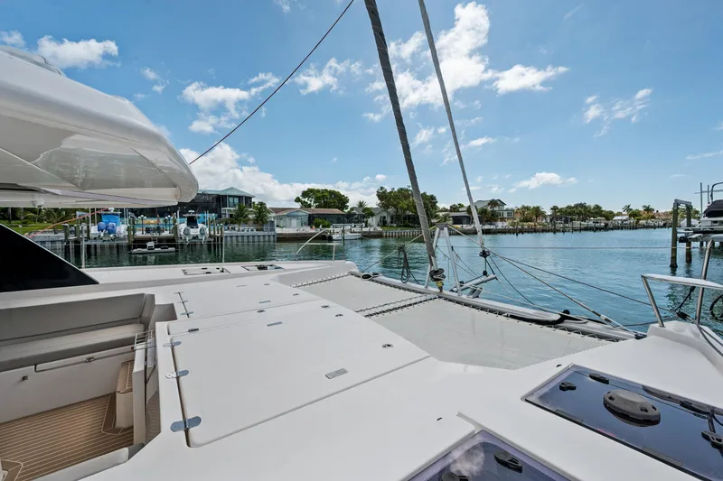 Slide: The Image of 2021 Leopard 45 catamaran deck with scenic waterfront view and clear blue sky. - 21