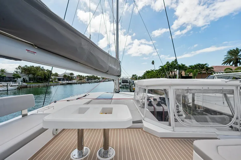 Slide: The Image of 2021 Leopard 45 catamaran deck with seating, table, and marina view. - 26