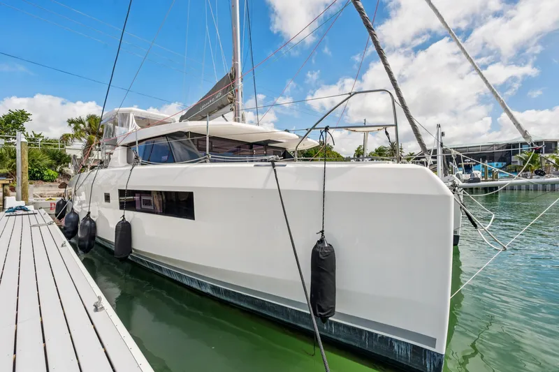 Slide: The Image of 2021 Leopard 45 catamaran docked at marina under blue sky. - 3