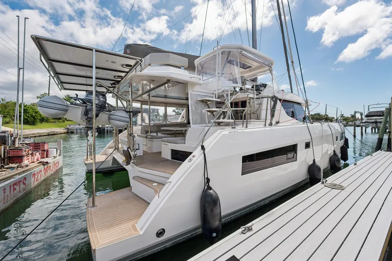 Slide: The Image of 2021 Leopard 45 catamaran docked, featuring modern design and spacious deck area. - 4