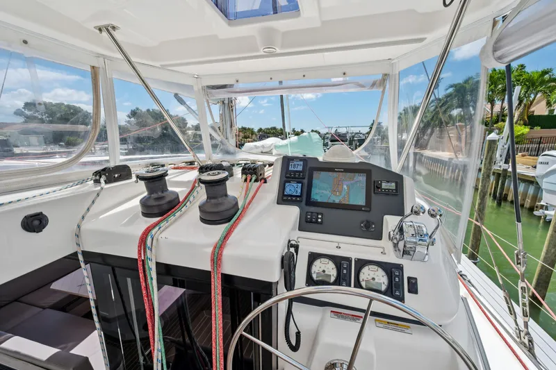 Slide: The Image of Cockpit of 2021 Leopard 45 catamaran with navigation equipment and steering wheel. - 54