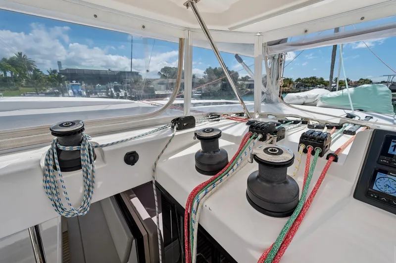 Slide: The Image of 2021 Leopard 45 yacht deck with winches and colorful ropes under clear sky. - 58