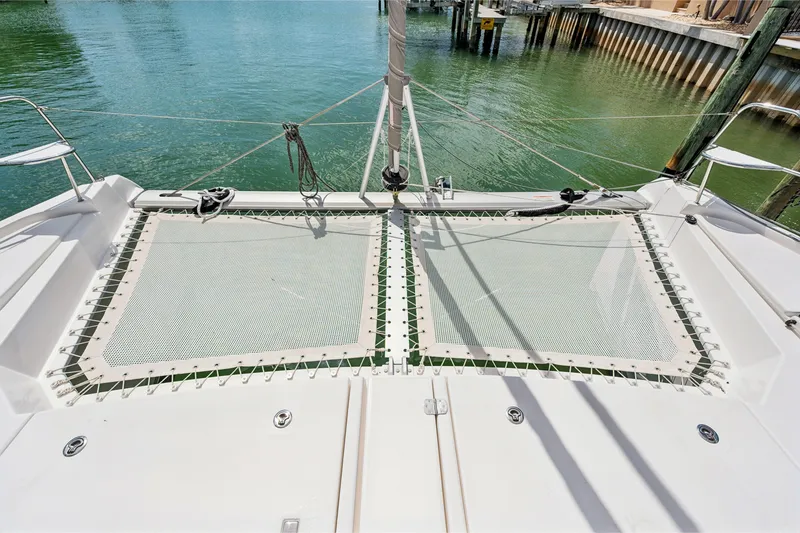 Slide: The Image of 2021 Leopard 45 catamaran deck with netting over calm water. - 6