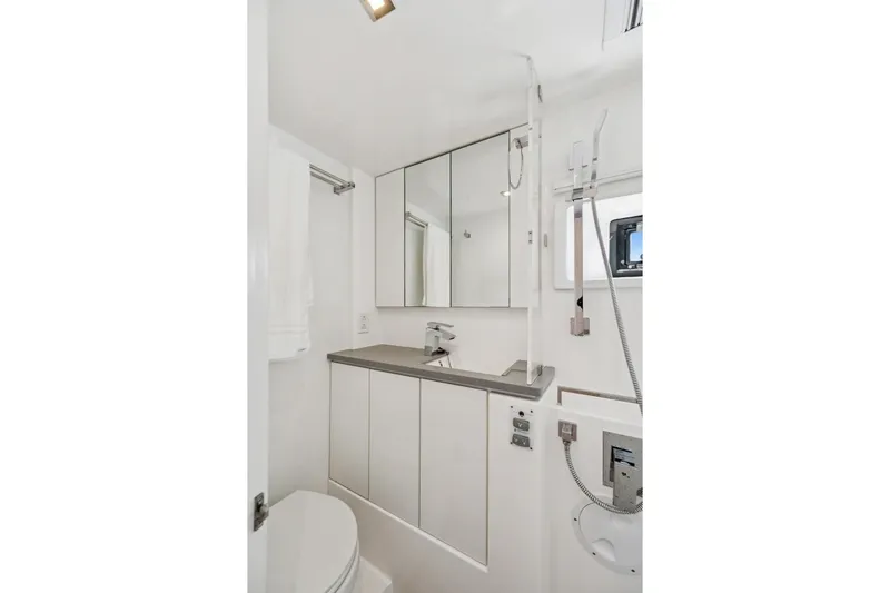 Slide: The Image of Modern bathroom in 2021 Leopard 45 yacht, featuring sleek design and mirrored cabinets. - 68