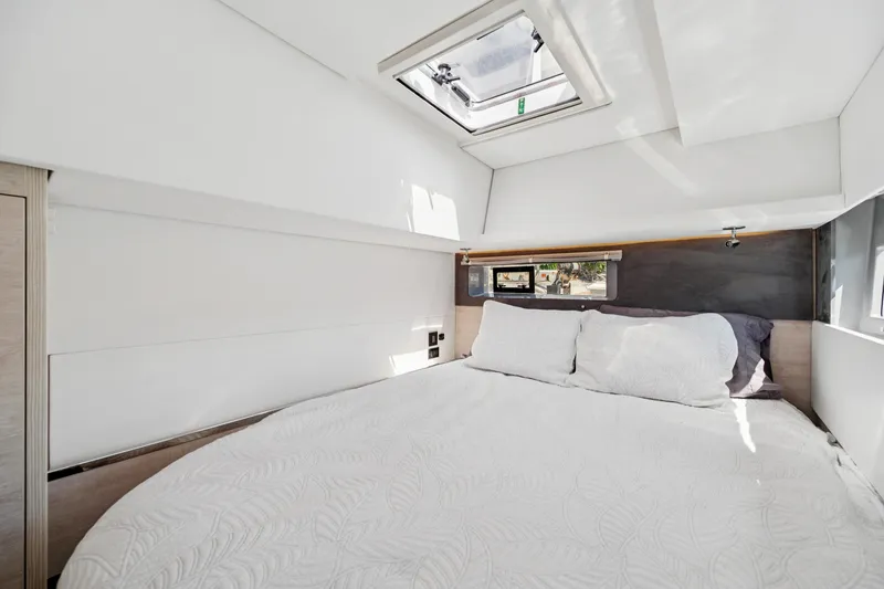 Slide: The Image of Luxurious bedroom interior of 2021 Leopard 45 yacht with skylight and cozy bedding. - 71