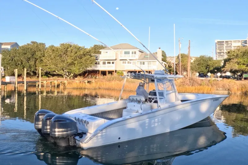 Slide: The Image of 2007 Cape Horn 36T boat with dual Yamaha engines on calm water near docks. - 11