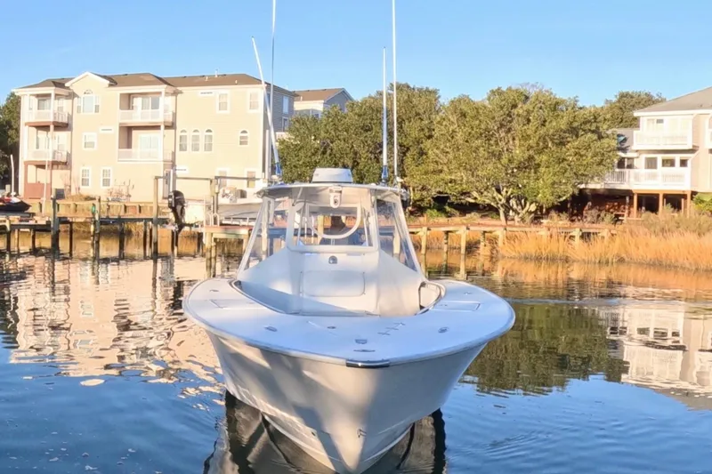 Slide: The Image of 2007 Cape Horn 36T boat docked near waterfront homes, reflecting on calm water. - 3