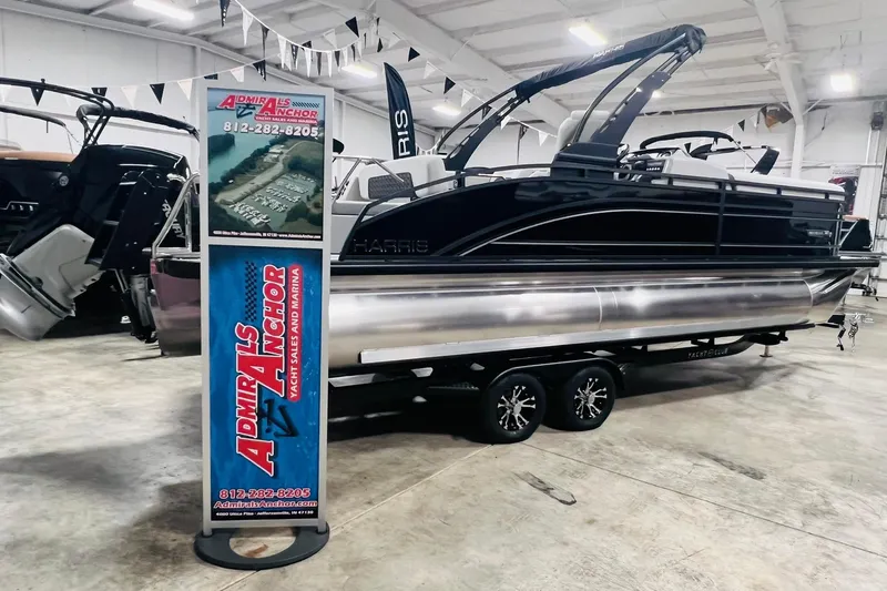 The Image of 2025 Harris Solstice 250 pontoon boat displayed indoors at Admiral's Anchor dealership. - 0
