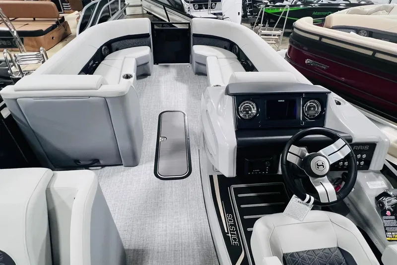 Slide: The Image of 2025 Harris Solstice 250 boat interior with modern dashboard and luxurious seating. - 14