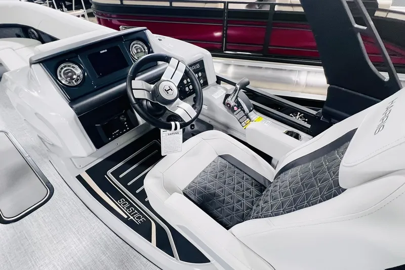 Slide: The Image of 2025 Harris Solstice 250 boat interior with modern steering and dashboard design. - 18