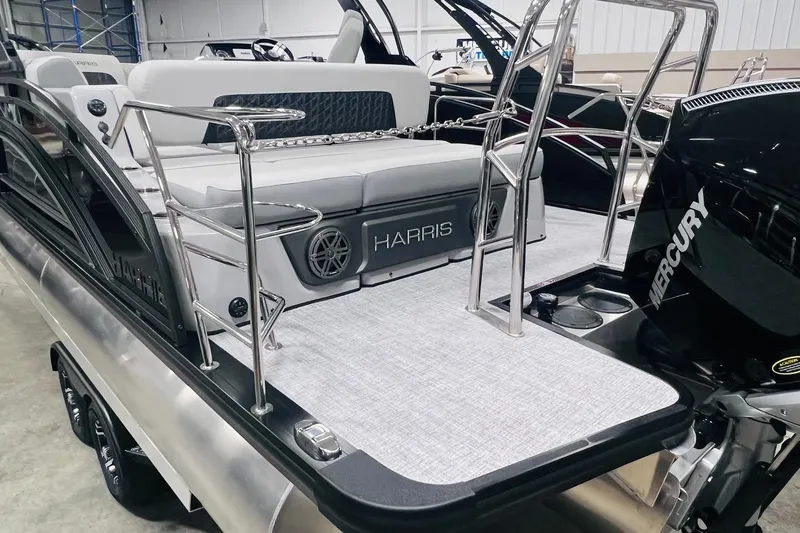 Slide: The Image of 2025 Harris Solstice 250 pontoon boat with Mercury engine, featuring sleek design and spacious seating. - 37