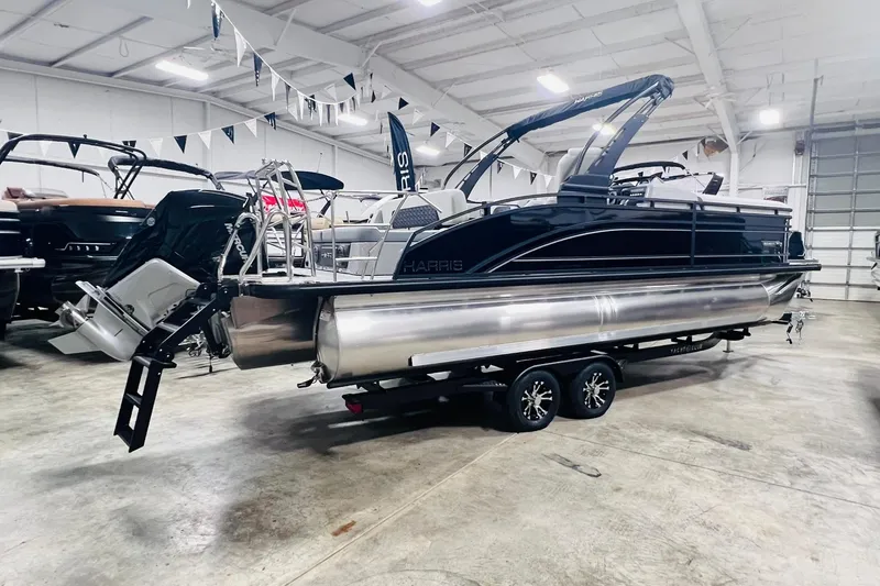 Slide: The Image of 2025 Harris Solstice 250 pontoon boat in showroom, featuring sleek design and modern amenities. - 4