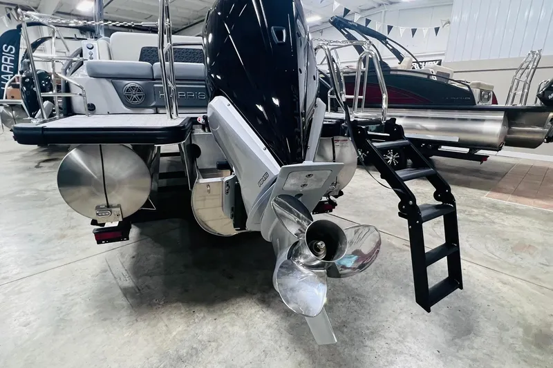 Slide: The Image of 2025 Harris Solstice 250 pontoon boat with powerful outboard motor and sleek design. - 41
