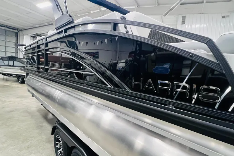 Slide: The Image of 2025 Harris Solstice 250 pontoon boat in a showroom, showcasing sleek design and modern features. - 50
