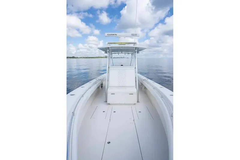 Slide: The Image of 2013 Contender 35 ST boat on calm water under a cloudy sky. - 13