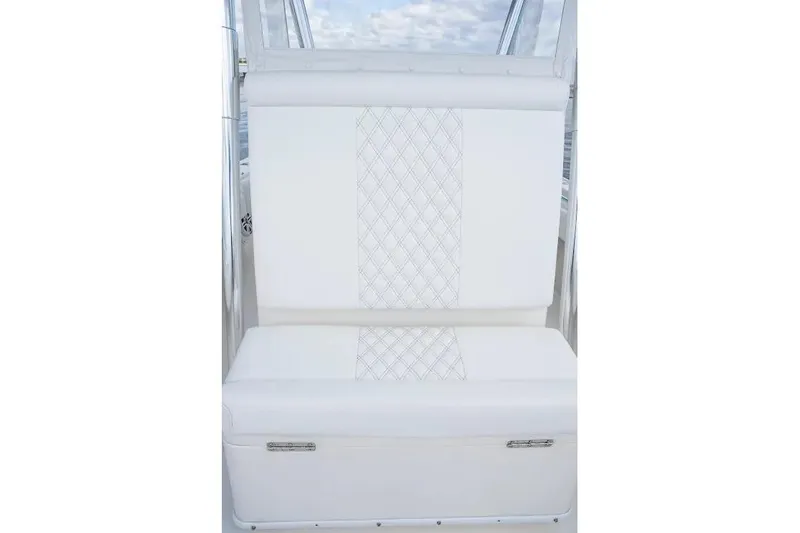 Slide: The Image of White cushioned seat with diamond pattern on a 2013 Contender 35 ST boat. - 14