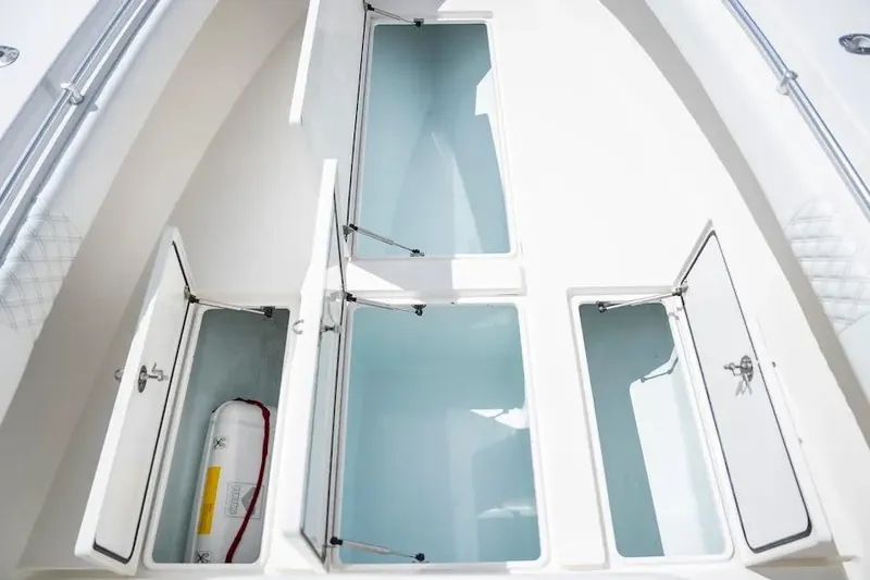 Slide: The Image of 2013 Contender 35 ST boat storage compartments with open hatches, showcasing interior space. - 15
